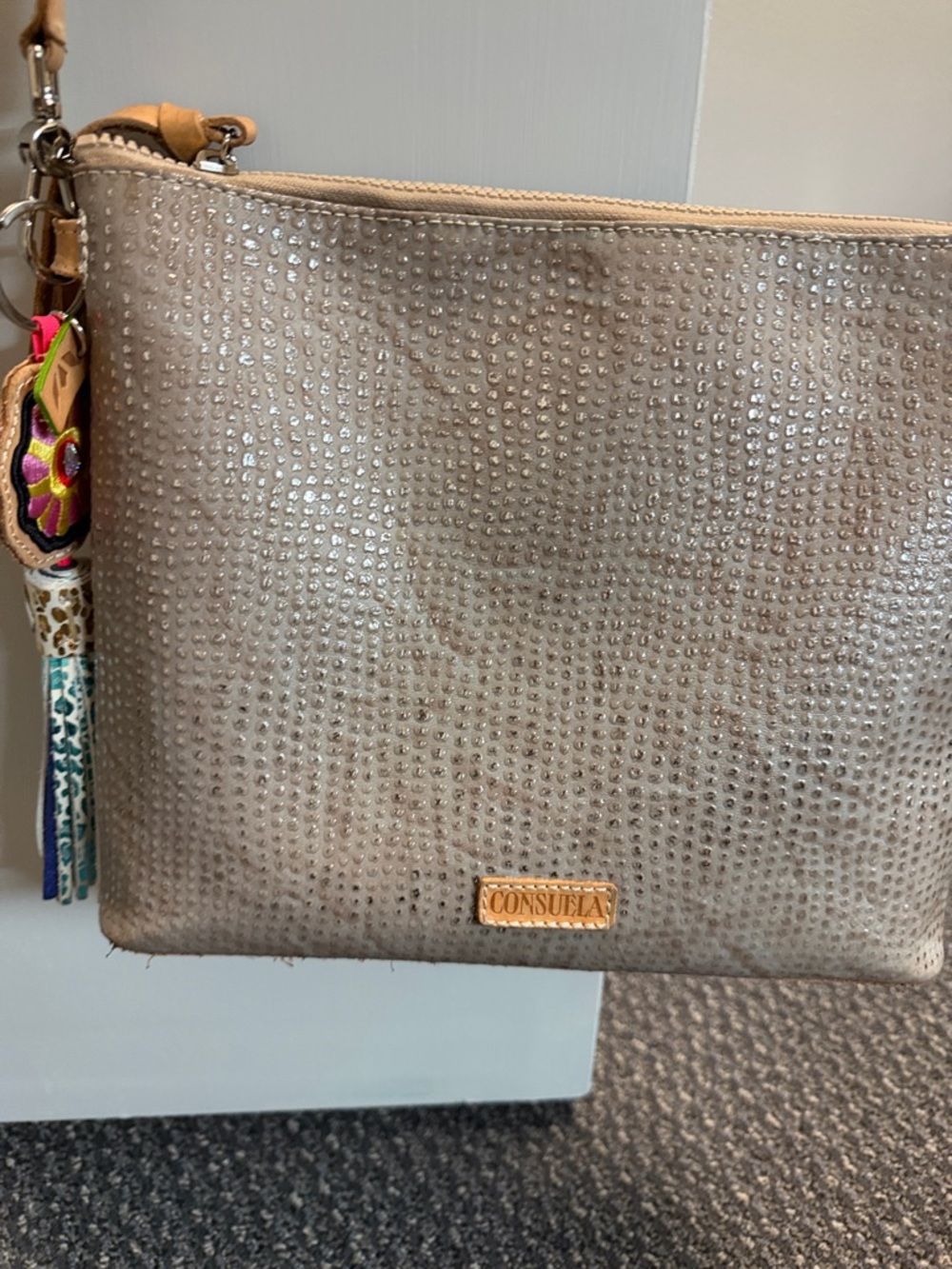Consuela taupe rhinestone-studded wristlet with tassel charm